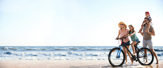 Family with bike on the beach